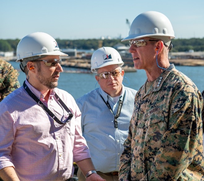 Pictured is Gen. Smith speaking with Ingalls Shipbuilding Vice President of Quality and Engineering and incoming President Brian Blanchette and Vice President of Operations Donny Dorsey aboard large-deck amphibious ship Bougainville (LHA 8).