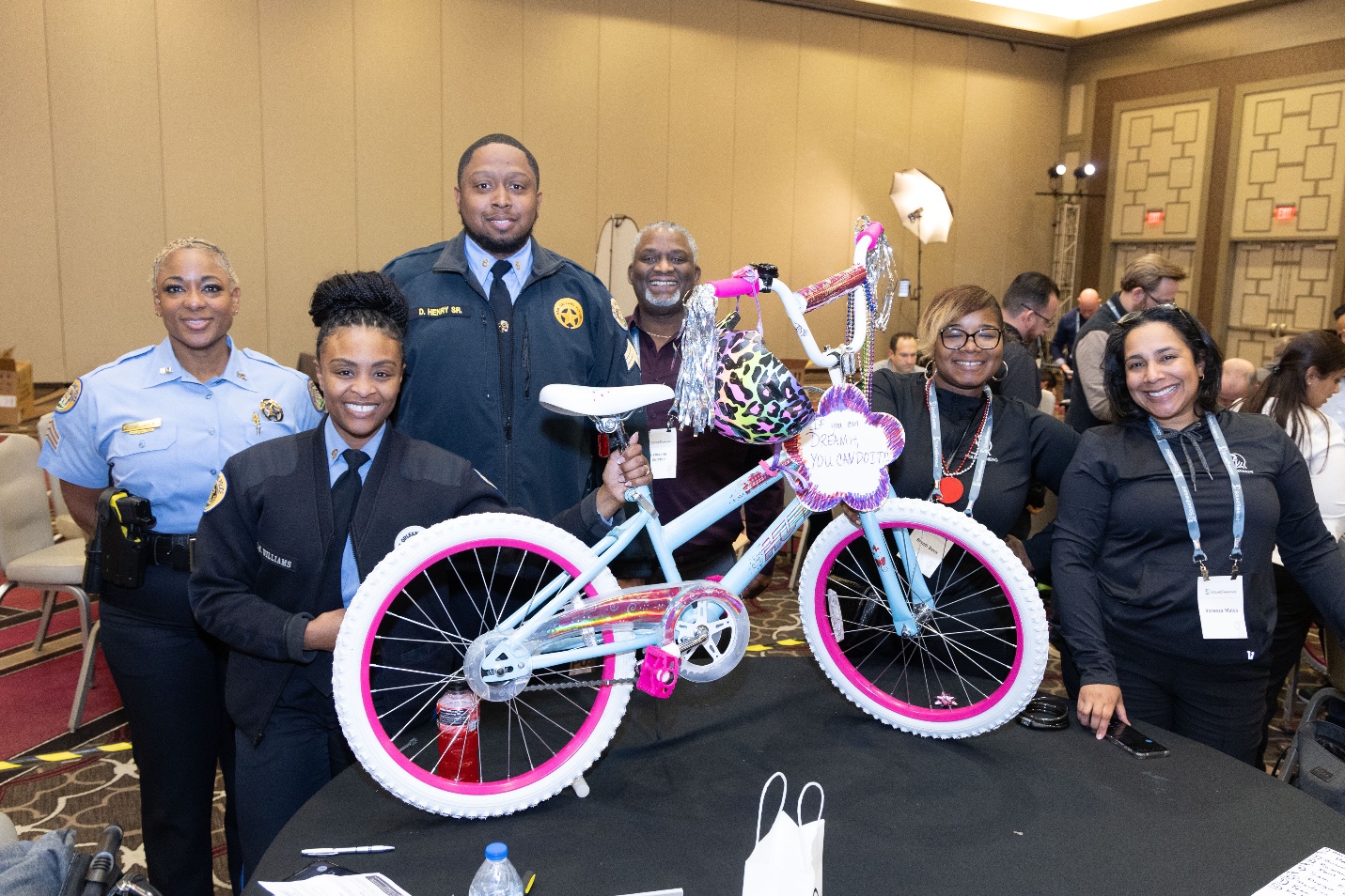 NOPD officers and SoundThinking team members showcase a completed customized bike that NORD will distribute to a child in New Orleans.