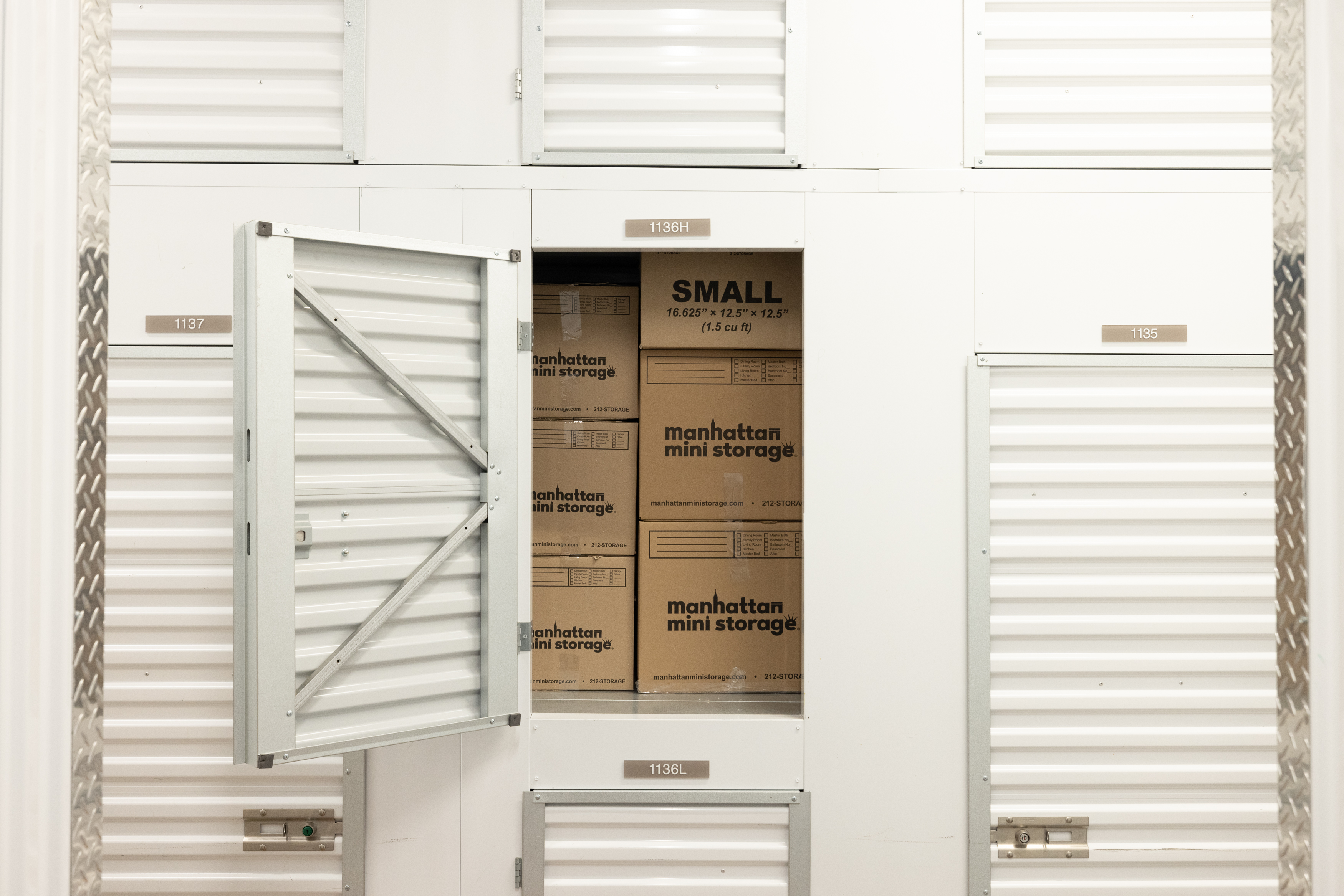 An open storage unit filled with Manhattan Mini Storage boxes
